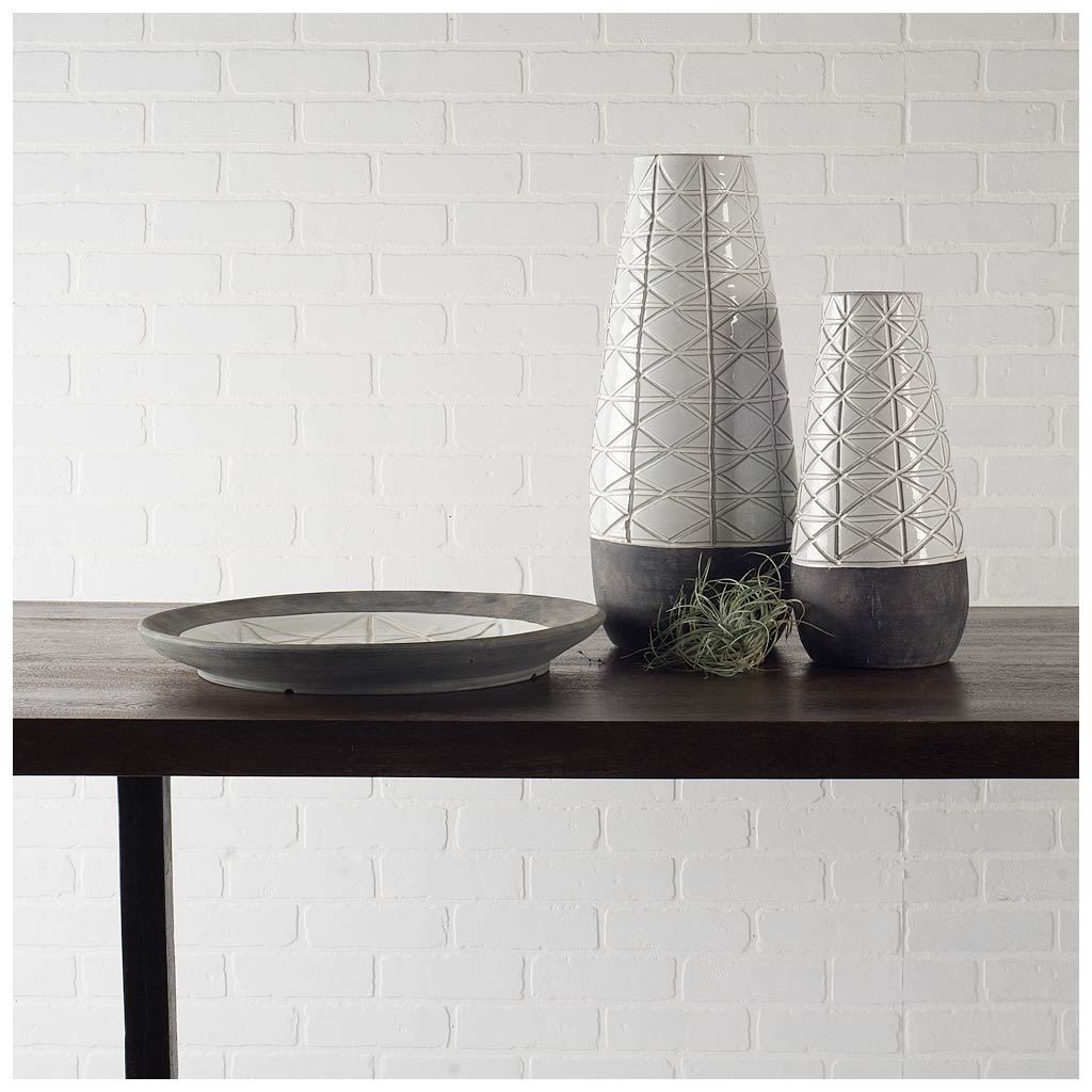 Carved Textured White Ceramic Vase Over Dark Clay