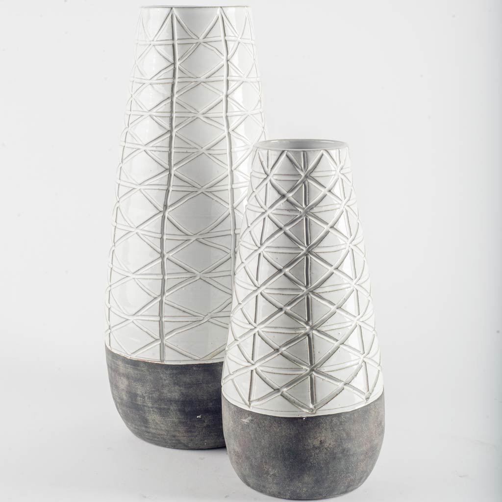 Carved Textured White Ceramic Vase Over Dark Clay
