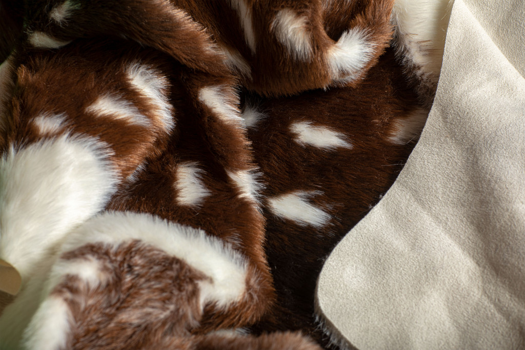 5" X 8" Off White And Brown Faux Cowhide Tufted Washable Non Skid Area Rug