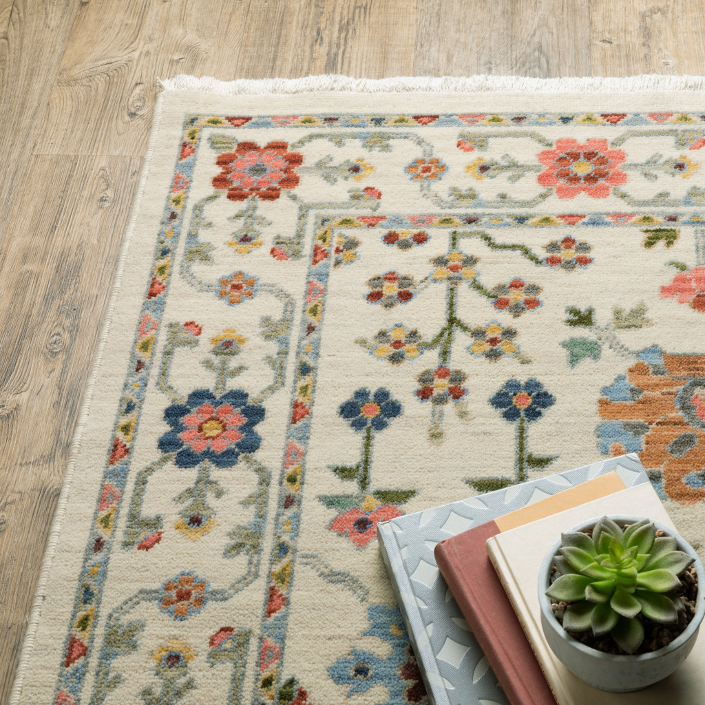 8" X 11" Ivory Salmon Pink Gold Blues Grey Rust And Green Oriental Power Loom Stain Resistant Area Rug With Fringe