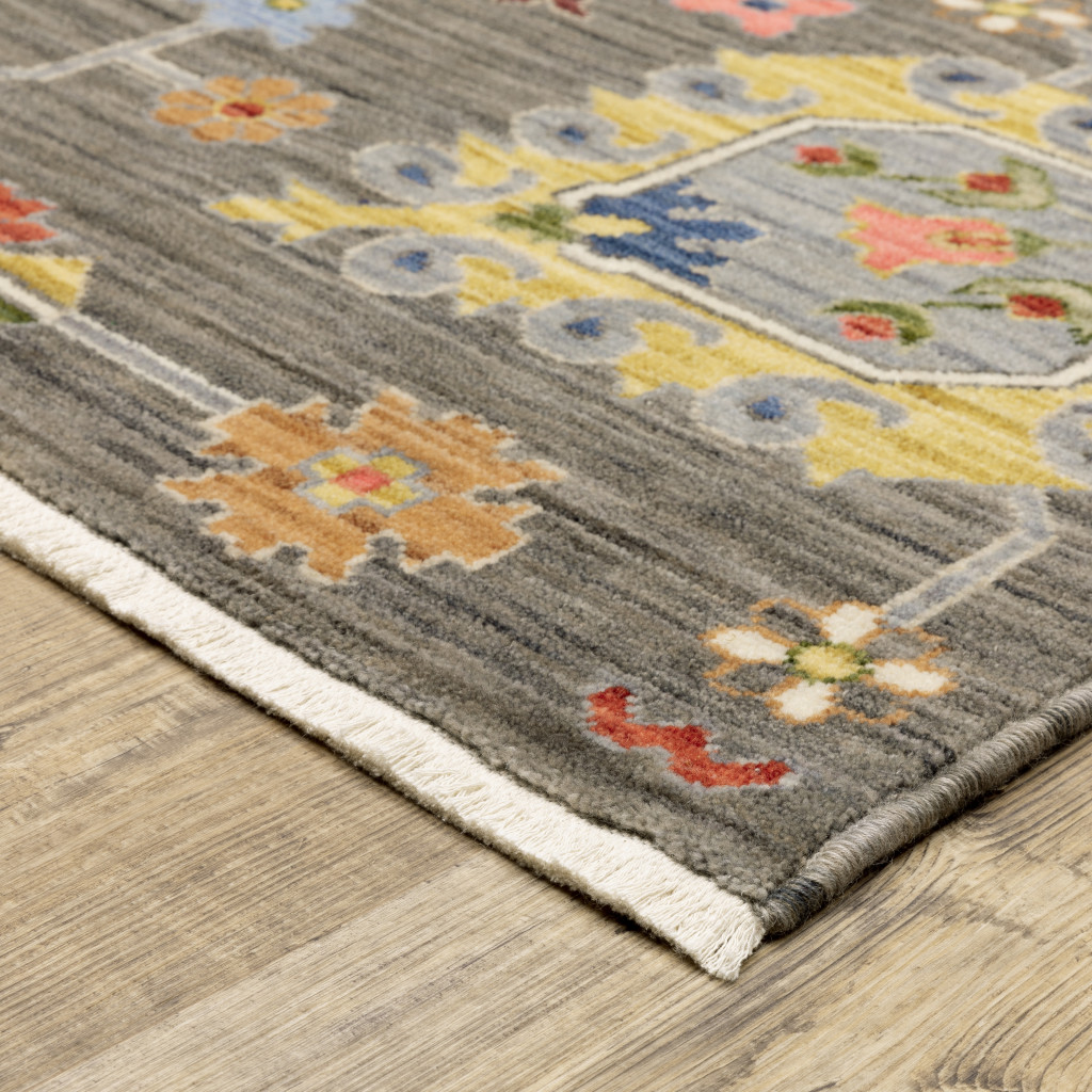 2" X 3" Grey Charcoal Yellow Blue Rust Red Pink Green And Ivory Oriental Power Loom Stain Resistant Area Rug With Fringe