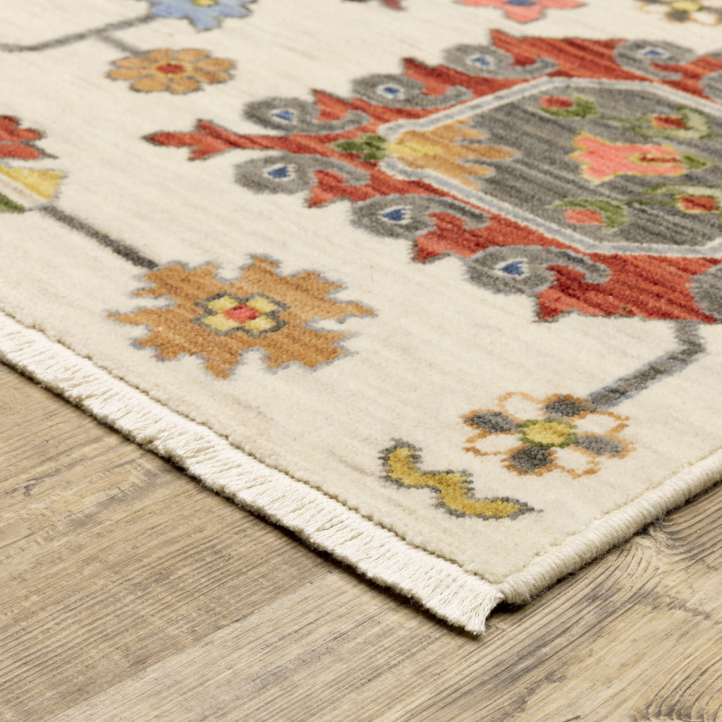 3" X 5" Ivory Yellow Rust Green Grey Pink Orange Blue And Grey Oriental Power Loom Stain Resistant Area Rug With Fringe