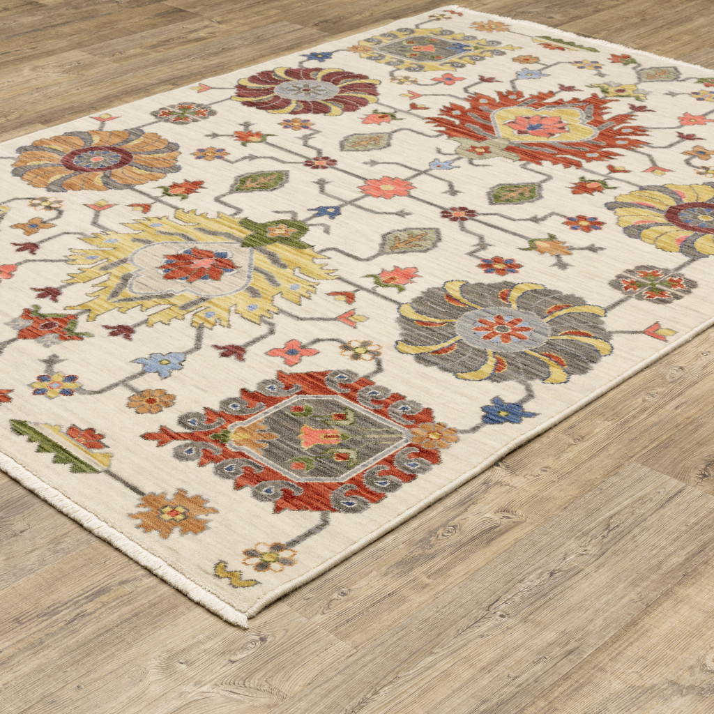3" X 5" Ivory Yellow Rust Green Grey Pink Orange Blue And Grey Oriental Power Loom Stain Resistant Area Rug With Fringe