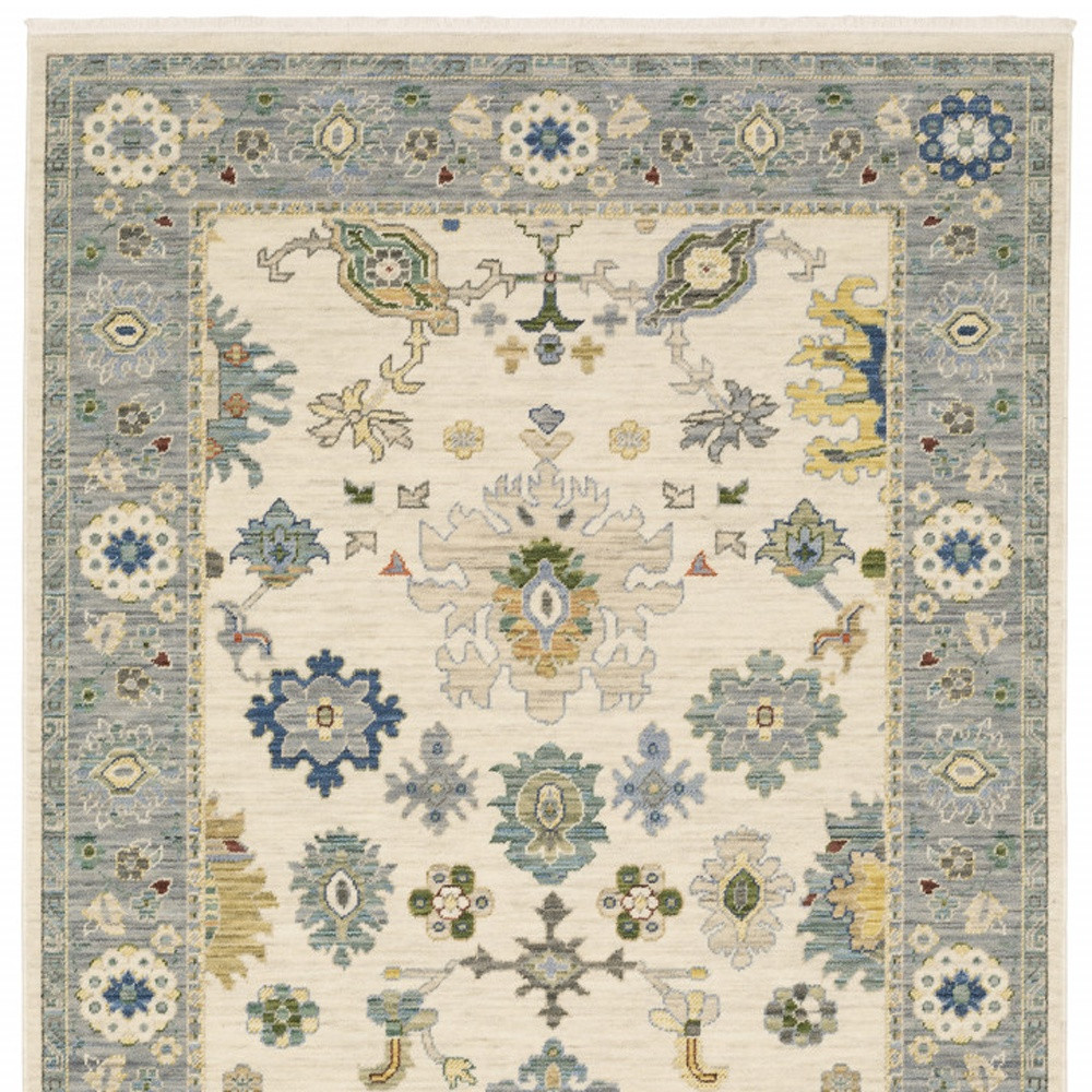 10" X 13" Ivory Blue Grey Teal Gold Green And Rust Oriental Power Loom Stain Resistant Area Rug With Fringe