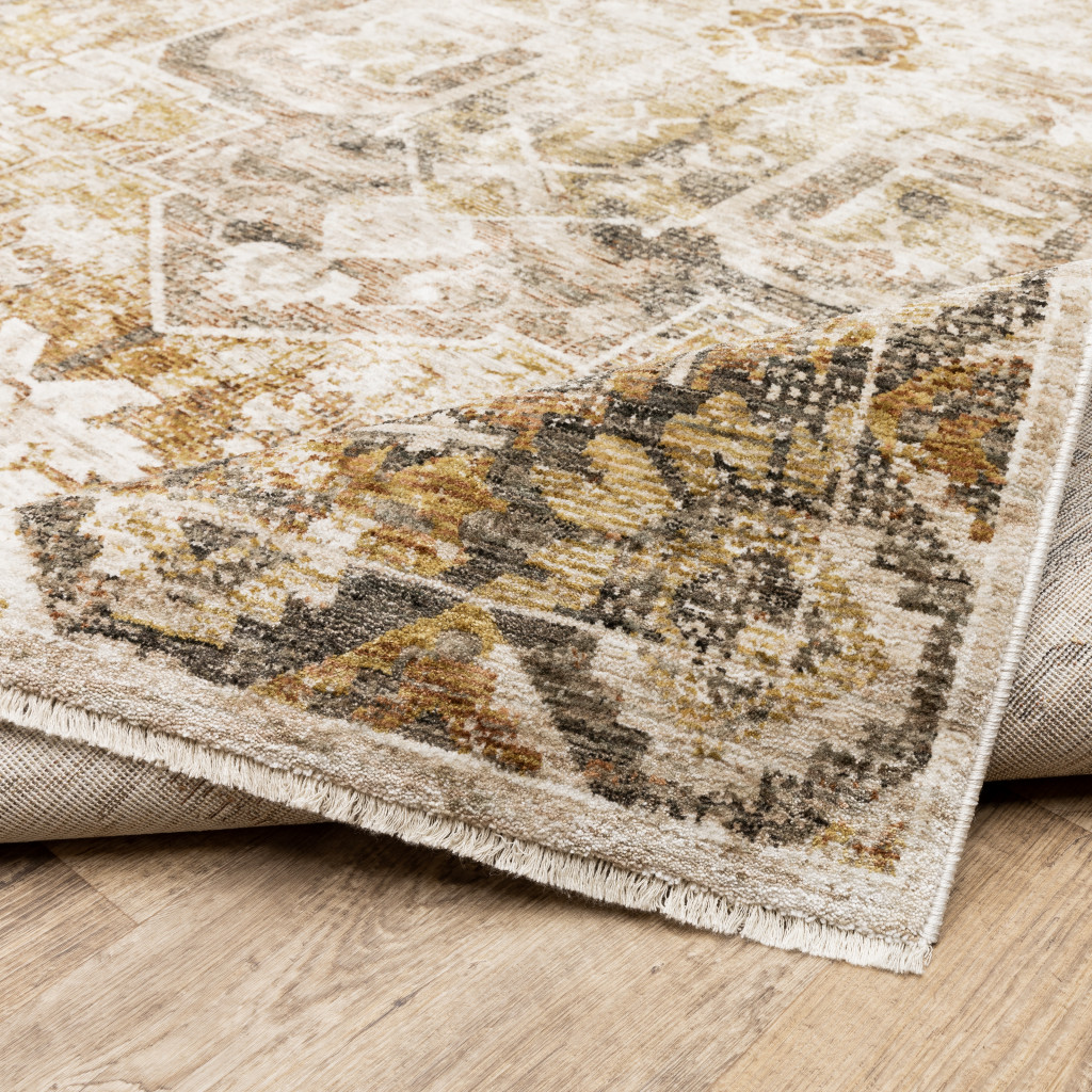 5" X 8" Gold And Ivory Oriental Power Loom Stain Resistant Area Rug With Fringe