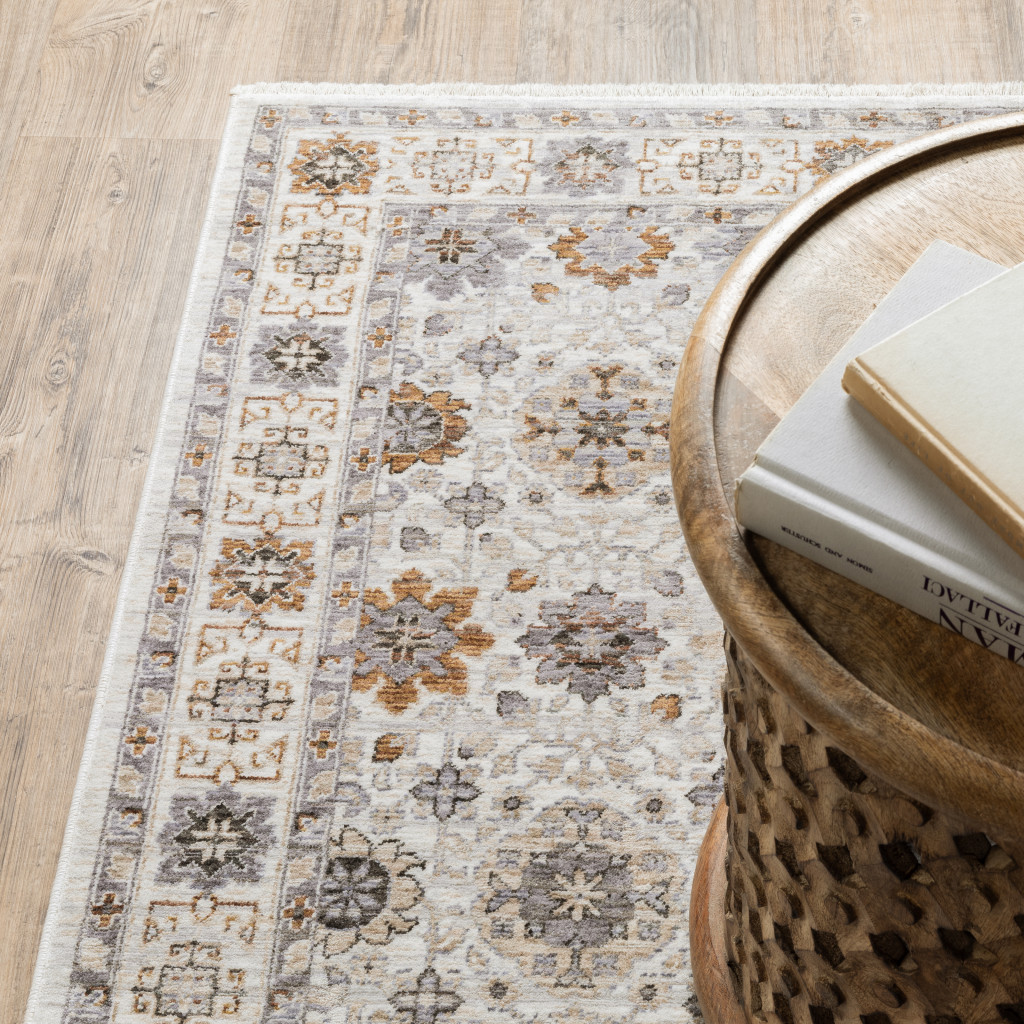 2" X 8" Ivory And Gold Oriental Power Loom Stain Resistant Runner Rug With Fringe