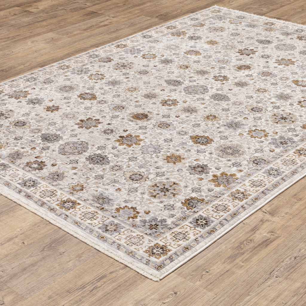 6" X 9" Ivory And Gold Oriental Power Loom Stain Resistant Area Rug With Fringe
