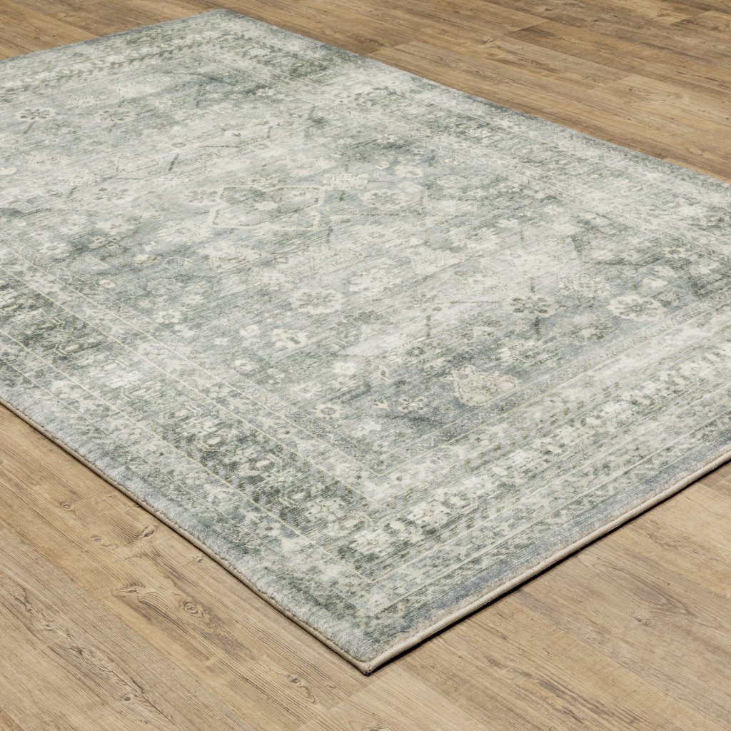 5" X 7" Blue Ivory And Grey Oriental Power Loom Stain Resistant Area Rug
