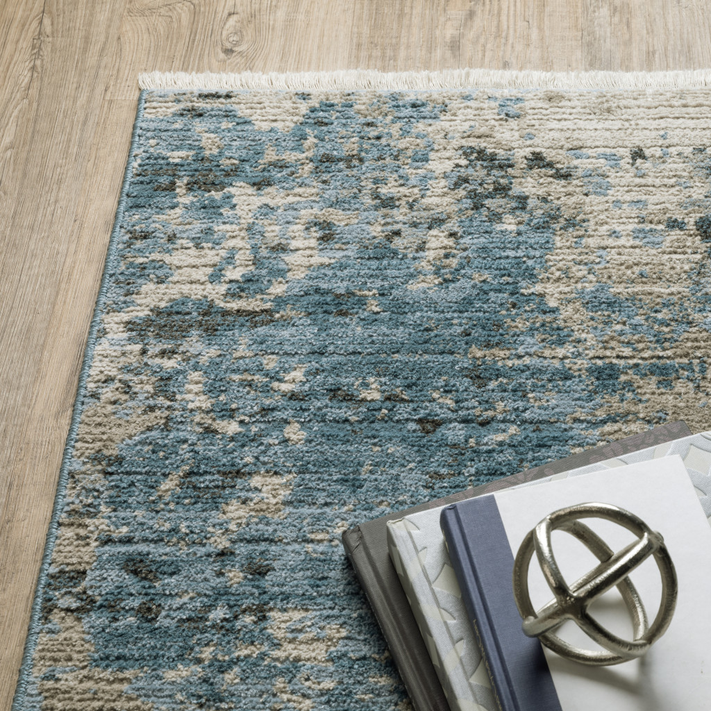 4" X 6" Blue Grey Ivory Light Blue And Dark Blue Abstract Power Loom Stain Resistant Area Rug With Fringe