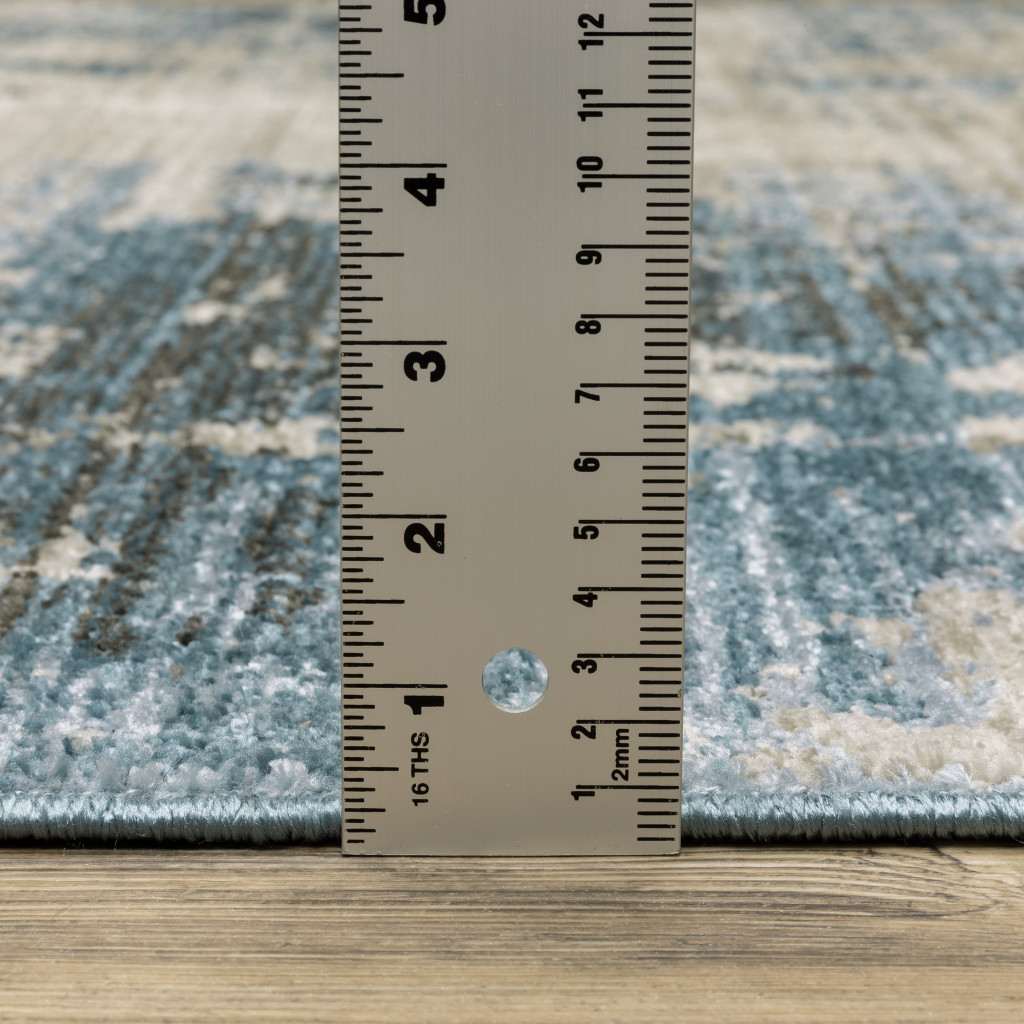 5" X 8" Blue Grey Ivory Light Blue And Dark Blue Abstract Power Loom Stain Resistant Area Rug With Fringe