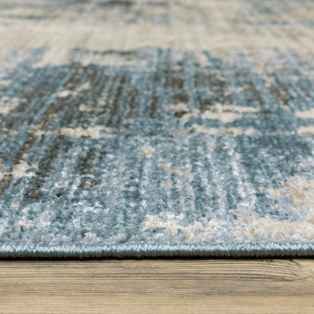 6" X 9" Blue Grey Ivory Light Blue And Dark Blue Abstract Power Loom Stain Resistant Area Rug With Fringe