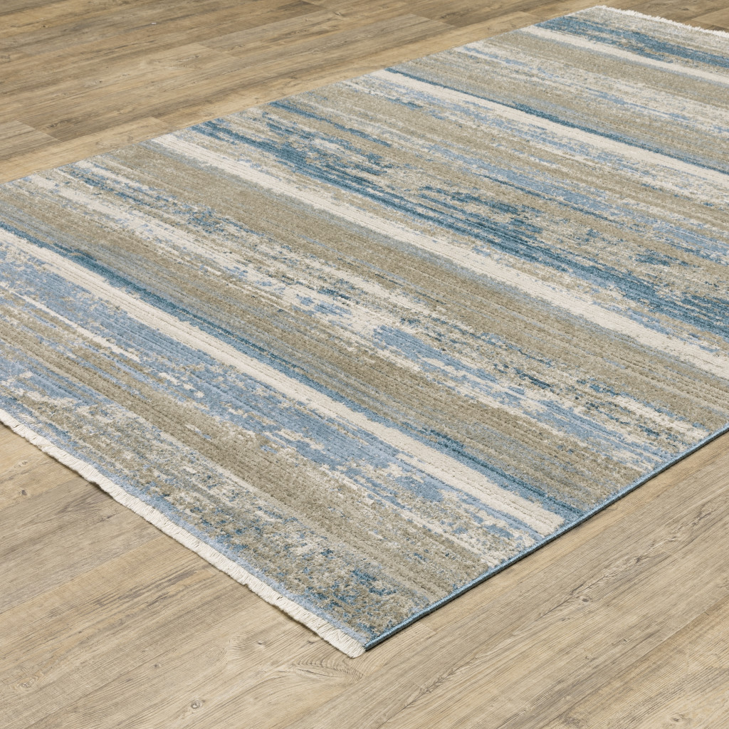 8" X 11" Ivory Beige Grey Blue And Tan Abstract Power Loom Stain Resistant Area Rug With Fringe