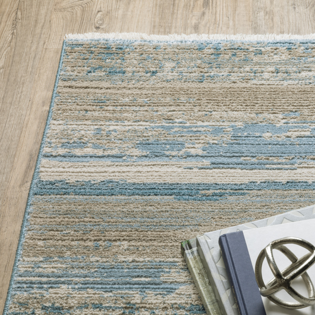 8" X 11" Ivory Beige Grey Blue And Tan Abstract Power Loom Stain Resistant Area Rug With Fringe