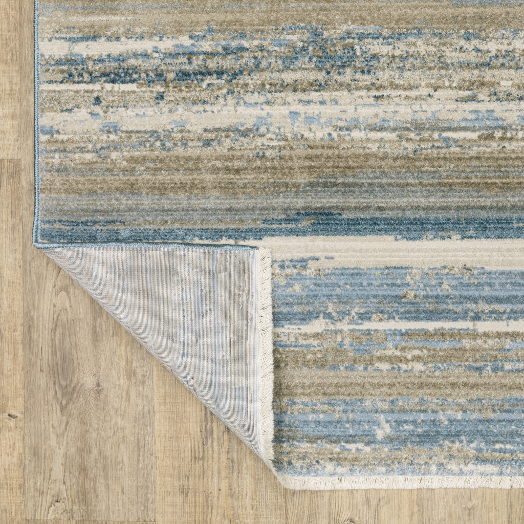 8" X 11" Ivory Beige Grey Blue And Tan Abstract Power Loom Stain Resistant Area Rug With Fringe
