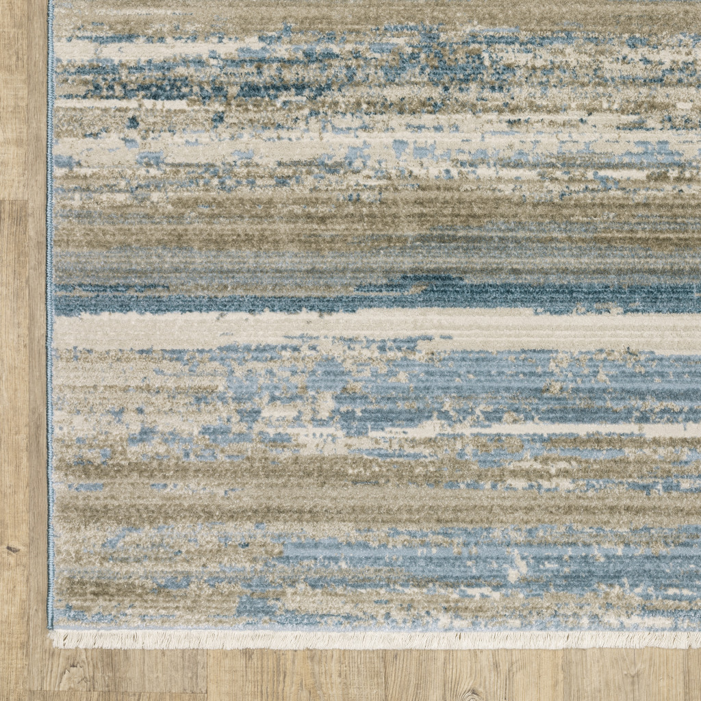 8" X 11" Ivory Beige Grey Blue And Tan Abstract Power Loom Stain Resistant Area Rug With Fringe
