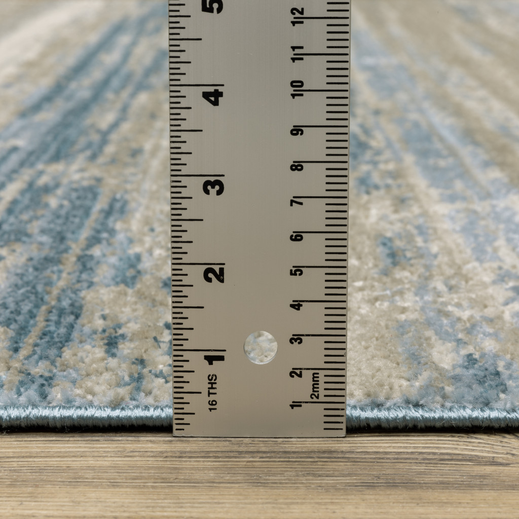8" X 11" Ivory Beige Grey Blue And Tan Abstract Power Loom Stain Resistant Area Rug With Fringe
