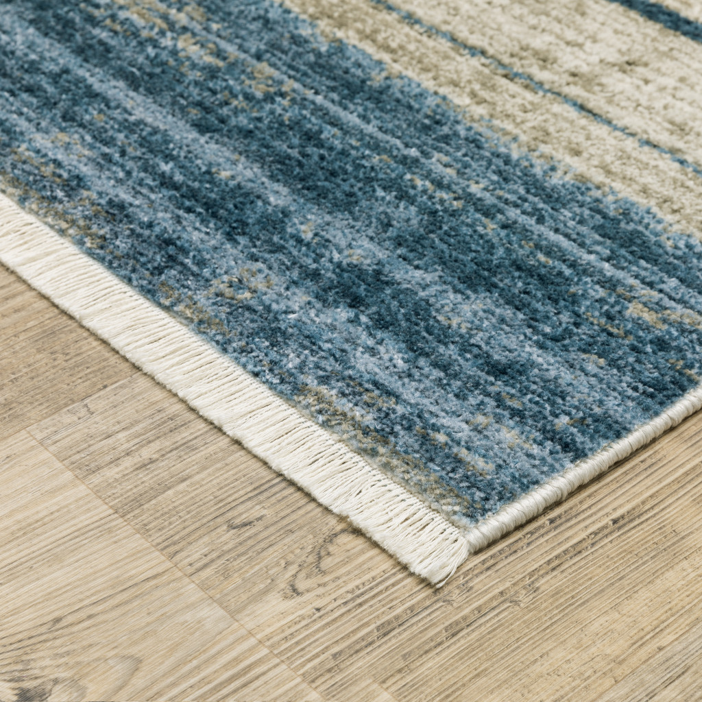 5" X 8" Blue Dark Blue Teal Grey Ivory Beige And Tan Geometric Power Loom Stain Resistant Area Rug With Fringe