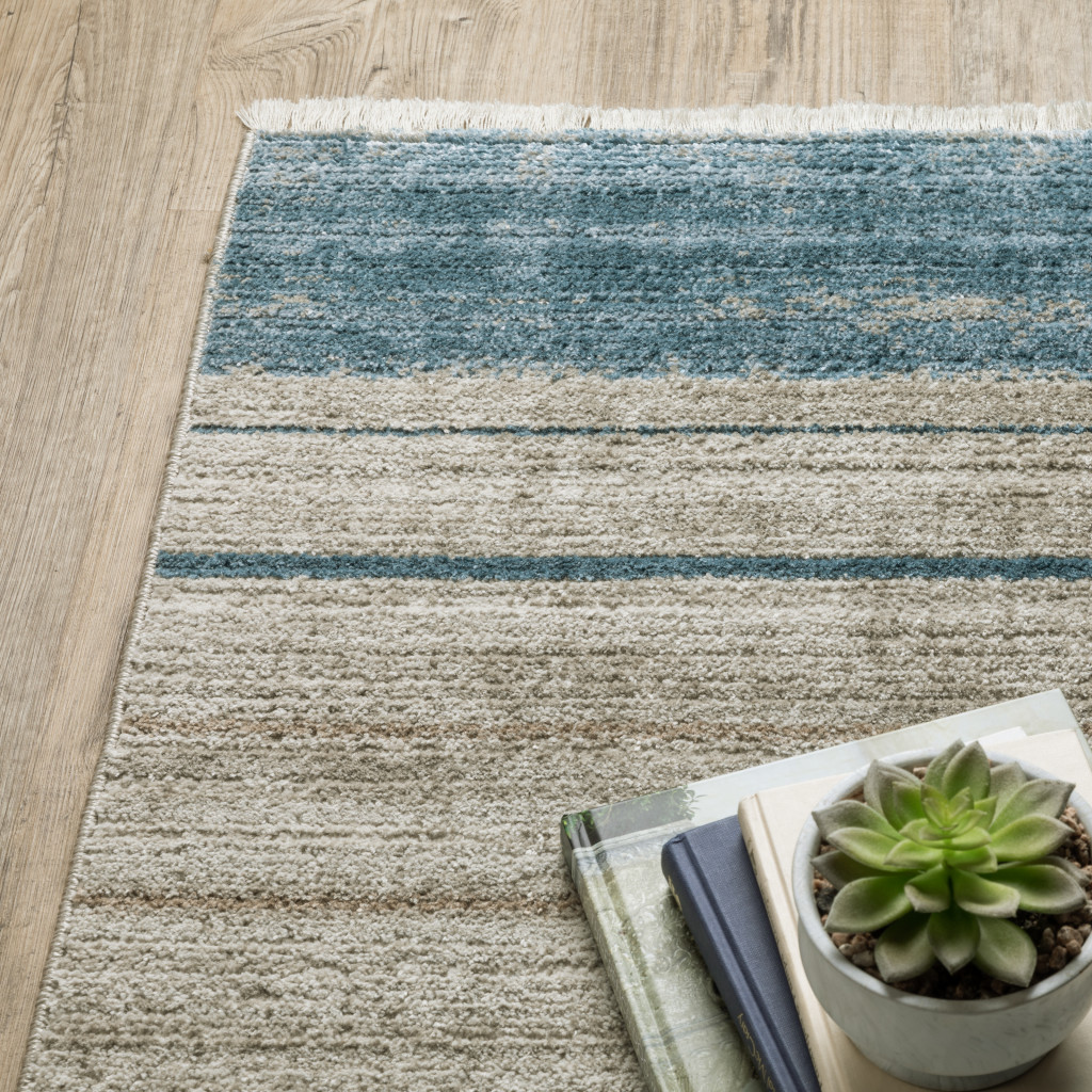 5" X 8" Blue Dark Blue Teal Grey Ivory Beige And Tan Geometric Power Loom Stain Resistant Area Rug With Fringe
