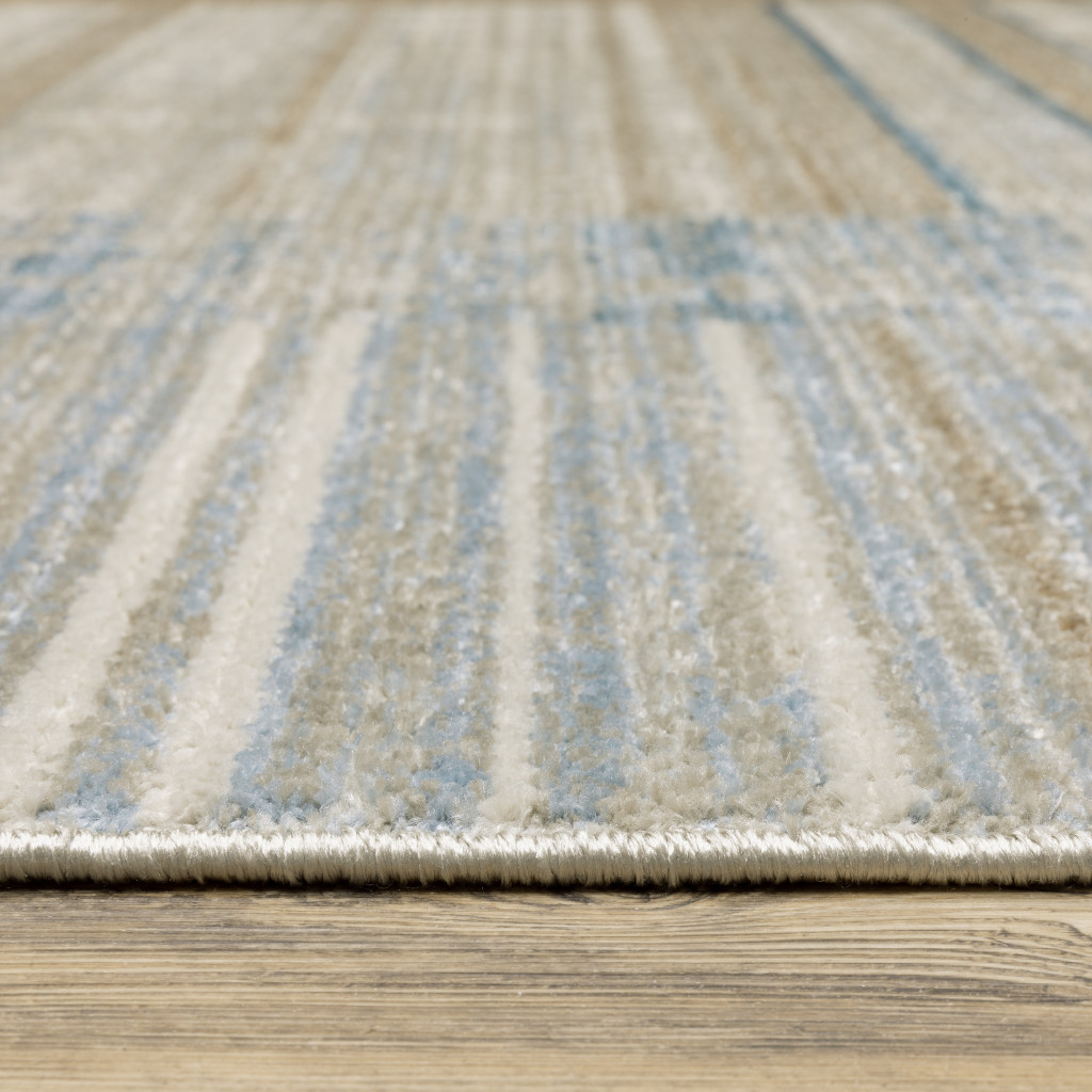 5" X 8" Blue Dark Blue Teal Grey Ivory Beige And Tan Geometric Power Loom Stain Resistant Area Rug With Fringe