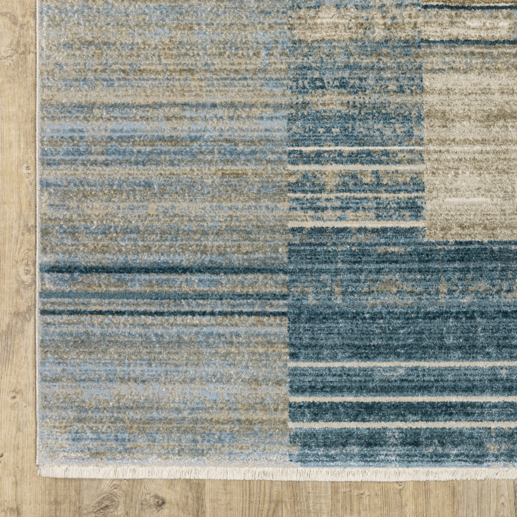 5" X 8" Blue Dark Blue Teal Grey Ivory Beige And Tan Geometric Power Loom Stain Resistant Area Rug With Fringe