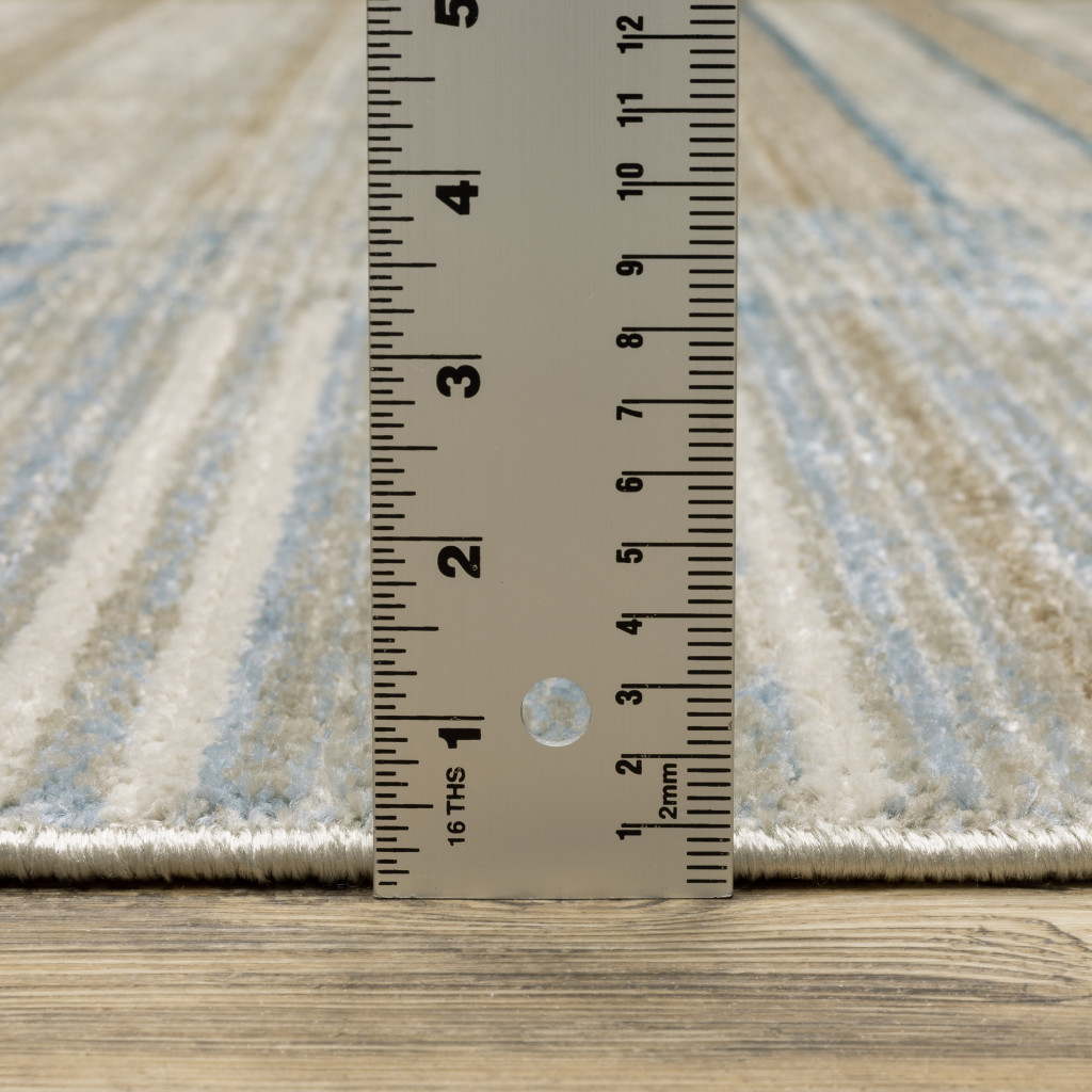 5" X 8" Blue Dark Blue Teal Grey Ivory Beige And Tan Geometric Power Loom Stain Resistant Area Rug With Fringe