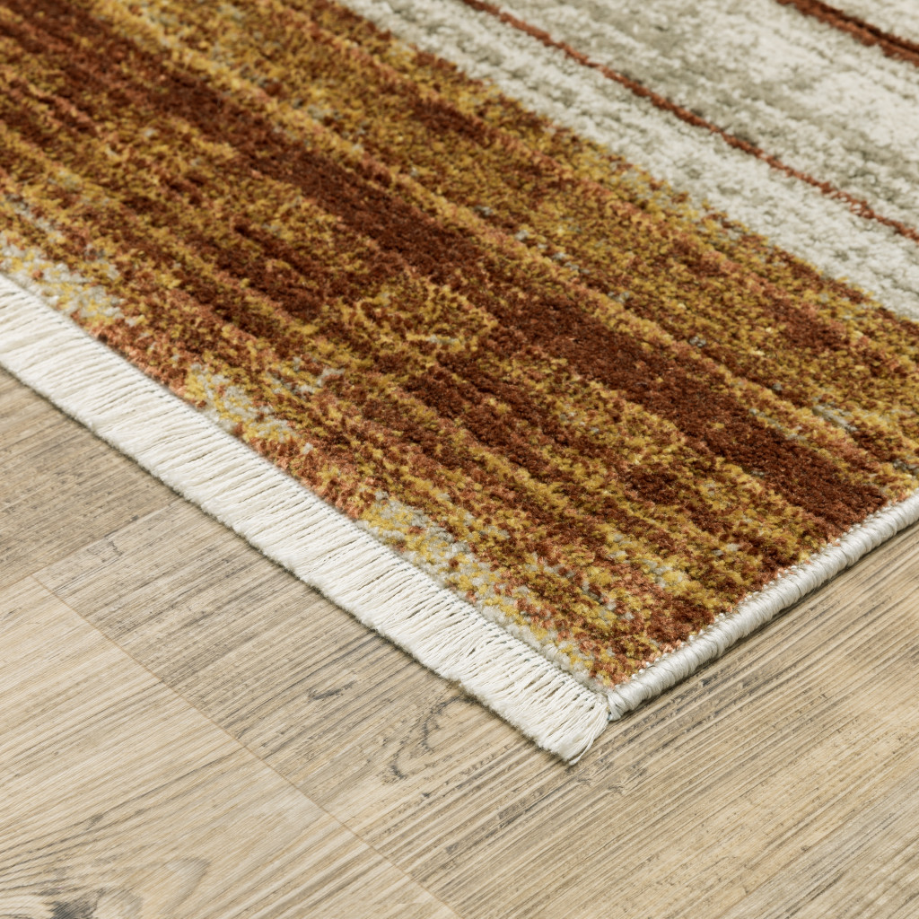 4" X 6" Rust Gold Blue Grey Ivory And Tan Geometric Power Loom Stain Resistant Area Rug With Fringe