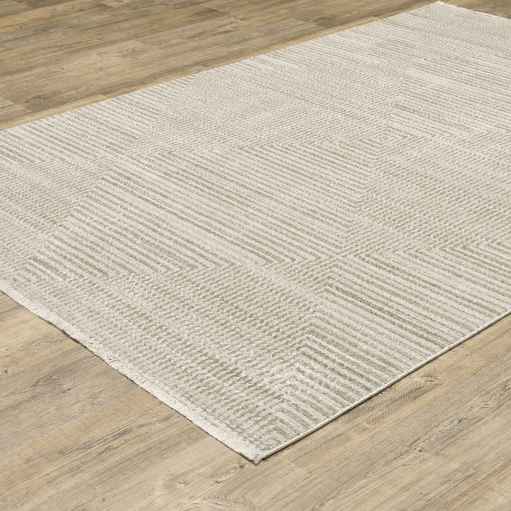 5" X 8" Ivory Beige Taupe And Tan Geometric Power Loom Stain Resistant Area Rug With Fringe