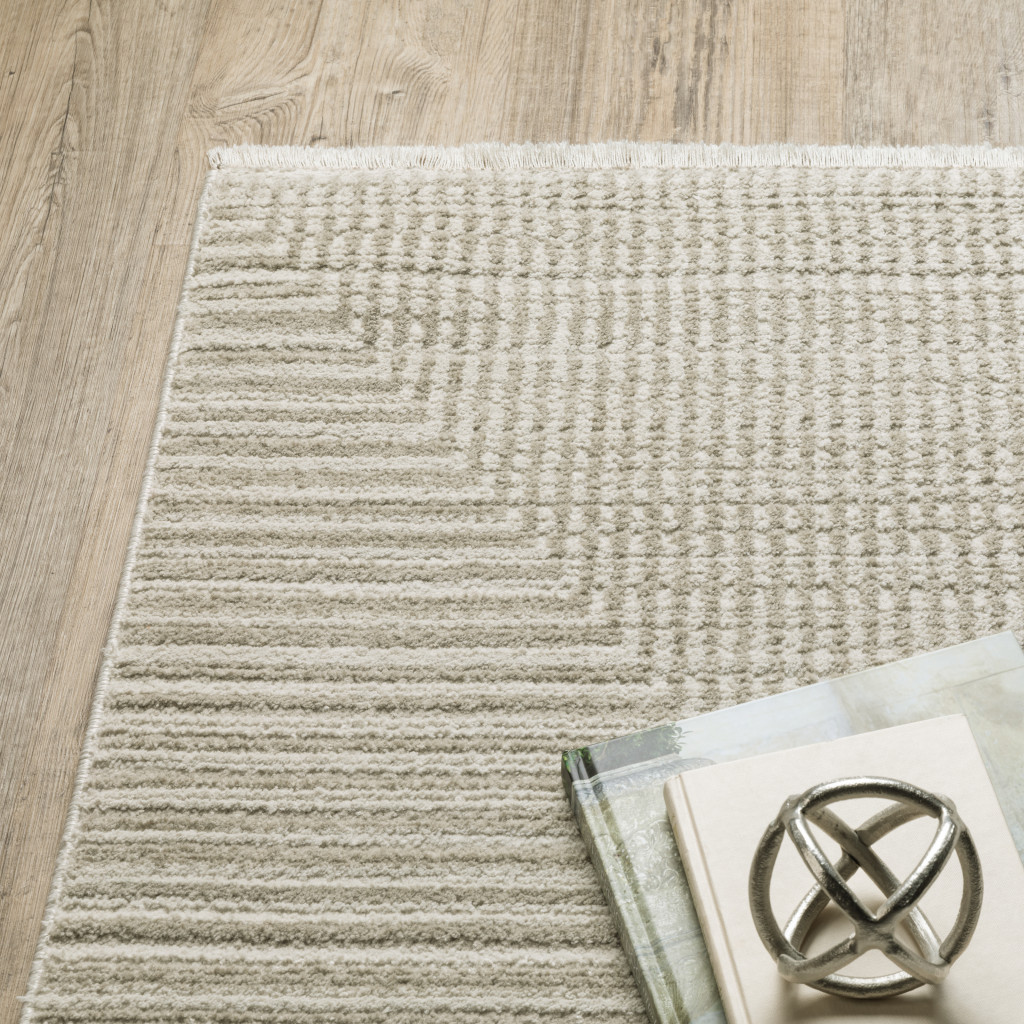 5" X 8" Ivory Beige Taupe And Tan Geometric Power Loom Stain Resistant Area Rug With Fringe