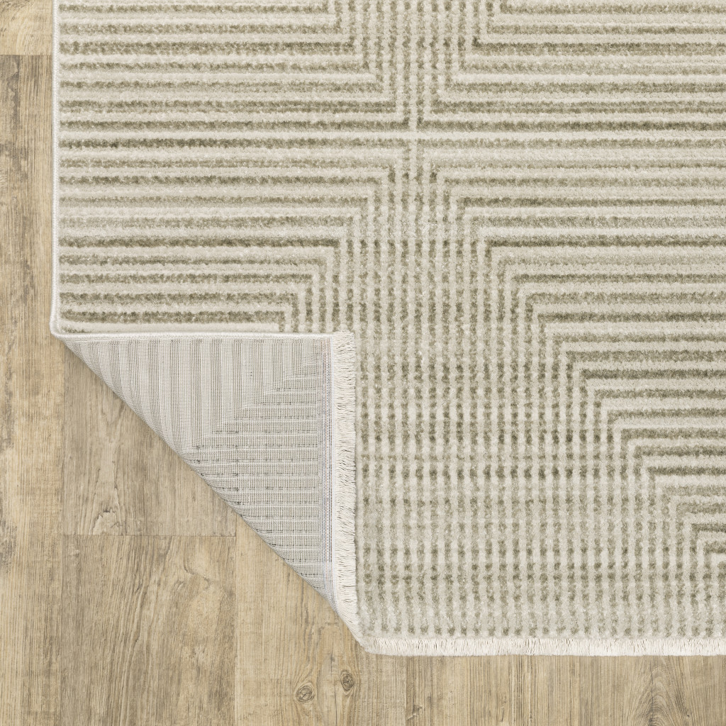 5" X 8" Ivory Beige Taupe And Tan Geometric Power Loom Stain Resistant Area Rug With Fringe