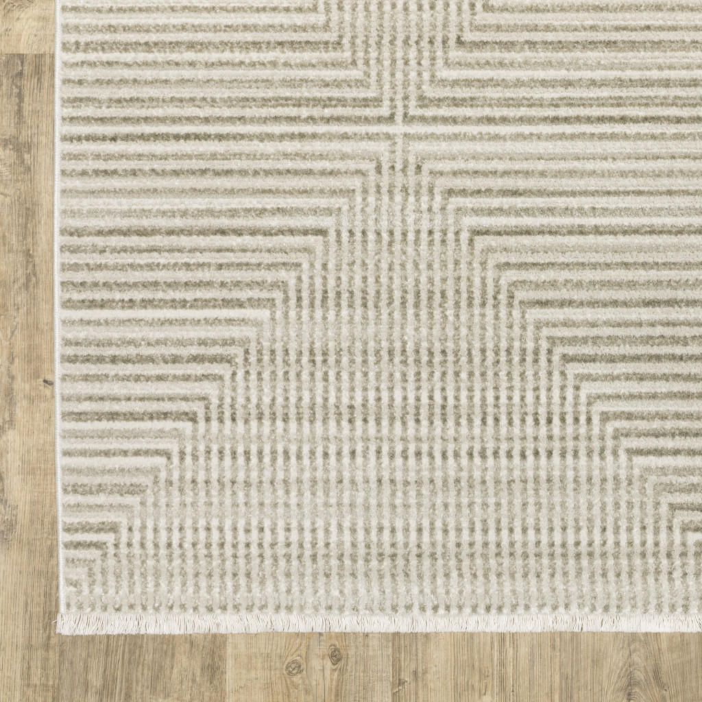 5" X 8" Ivory Beige Taupe And Tan Geometric Power Loom Stain Resistant Area Rug With Fringe