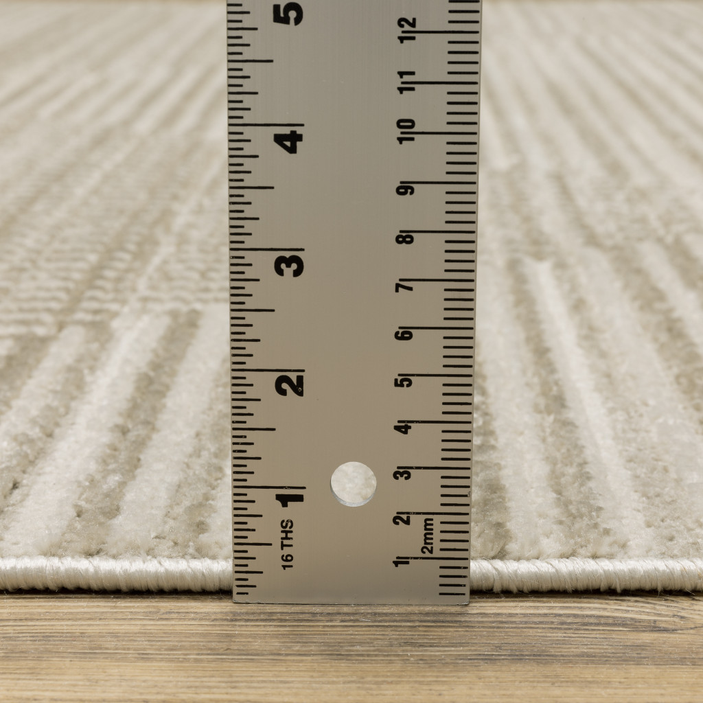 5" X 8" Ivory Beige Taupe And Tan Geometric Power Loom Stain Resistant Area Rug With Fringe