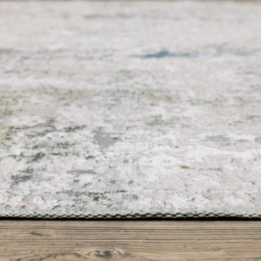 2" X 3" Ivory And Blue Abstract Printed Stain Resistant Non Skid Area Rug