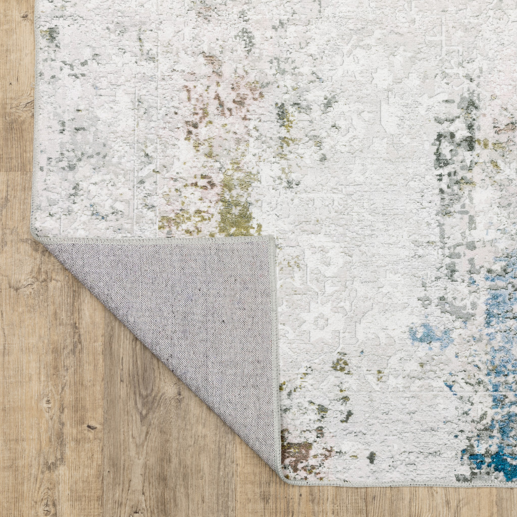 2" X 3" Ivory And Blue Abstract Printed Stain Resistant Non Skid Area Rug