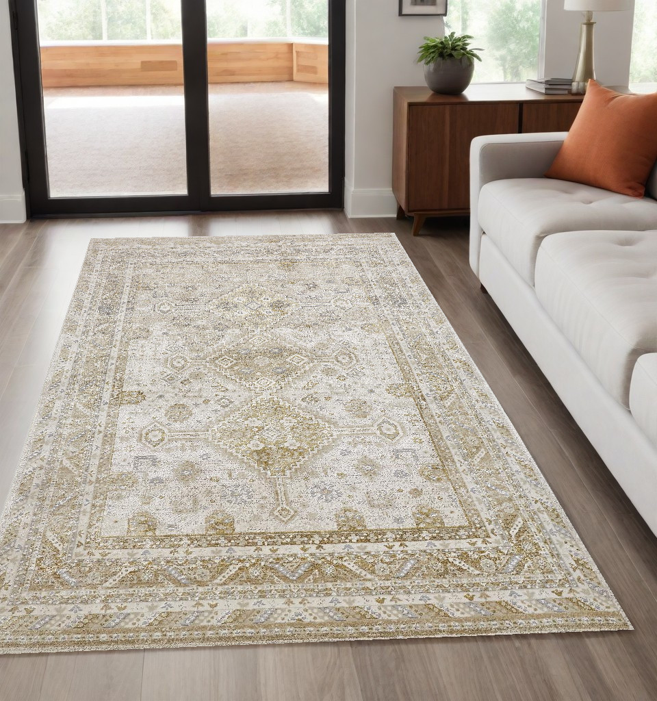 5" X 8" Gold And Ivory Floral Stain Resistant Area Rug