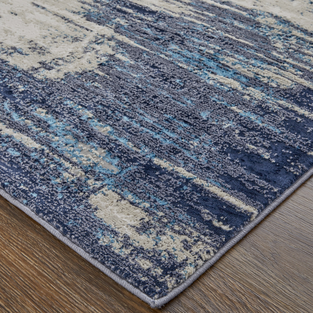 7" X 10" Tan Blue And Ivory Abstract Power Loom Distressed Area Rug