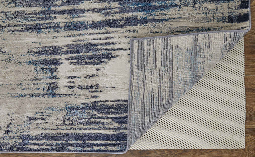 7" X 10" Tan Blue And Ivory Abstract Power Loom Distressed Area Rug