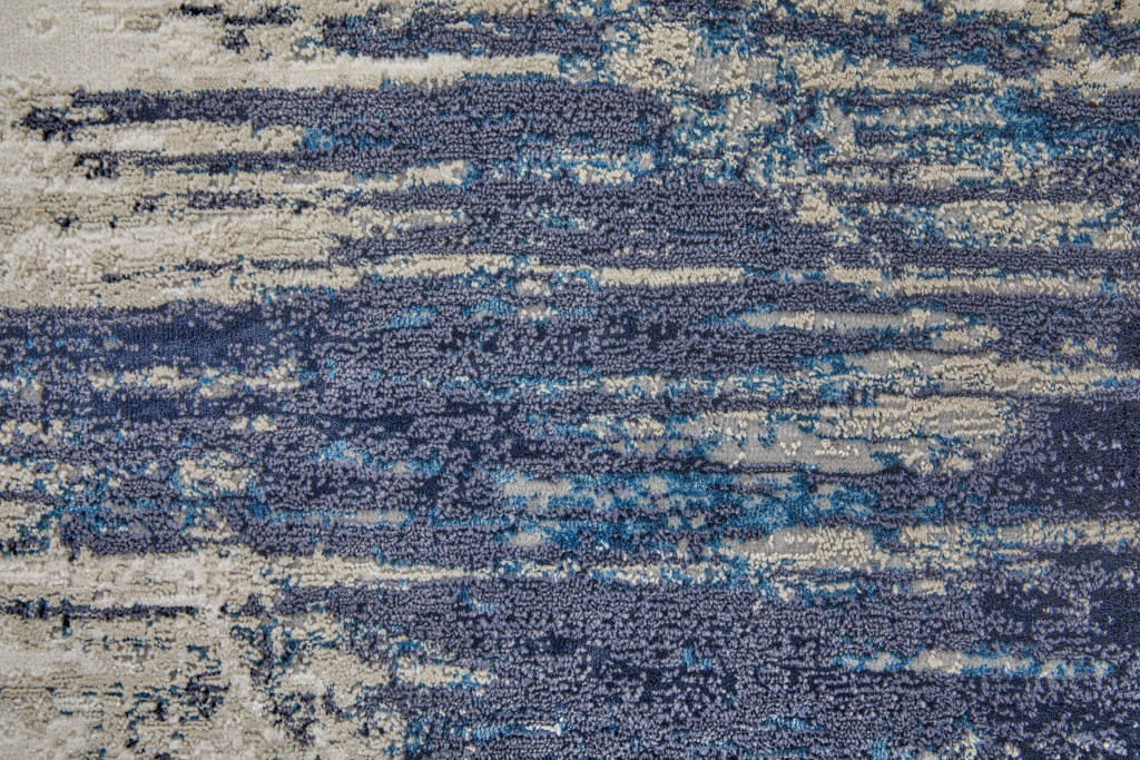 7" X 10" Tan Blue And Ivory Abstract Power Loom Distressed Area Rug