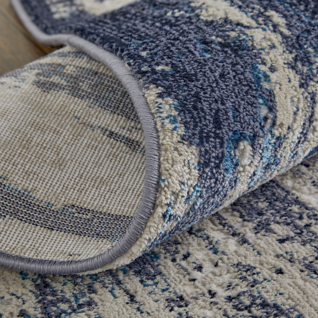 7" X 10" Tan Blue And Ivory Abstract Power Loom Distressed Area Rug