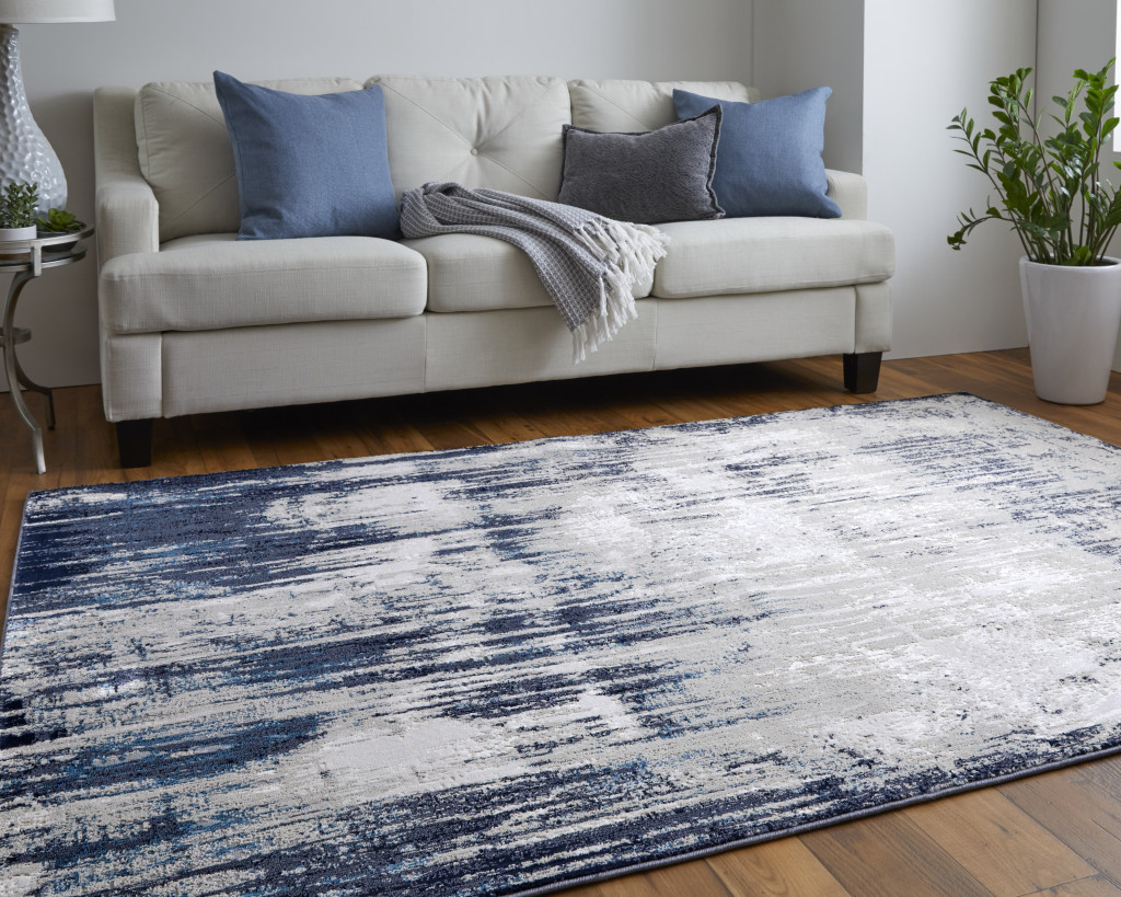9" X 12" Tan Blue And Ivory Abstract Power Loom Distressed Area Rug