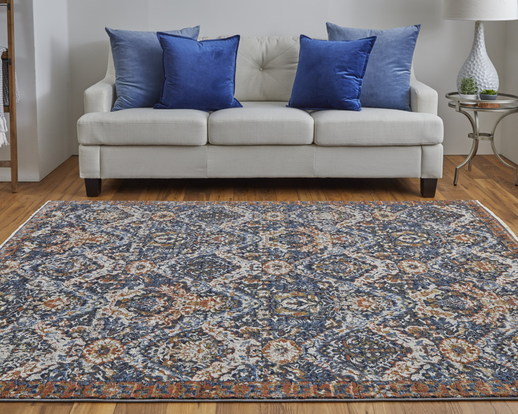 10" X 13" Blue Orange And Ivory Floral Power Loom Area Rug With Fringe