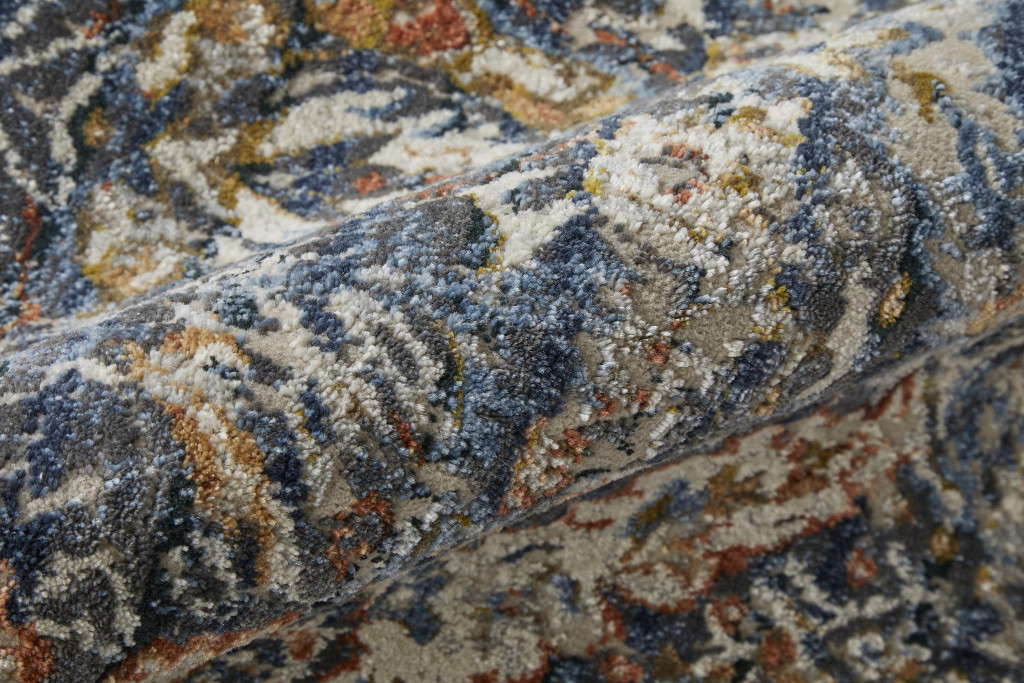 10" X 13" Blue Orange And Ivory Floral Power Loom Area Rug With Fringe