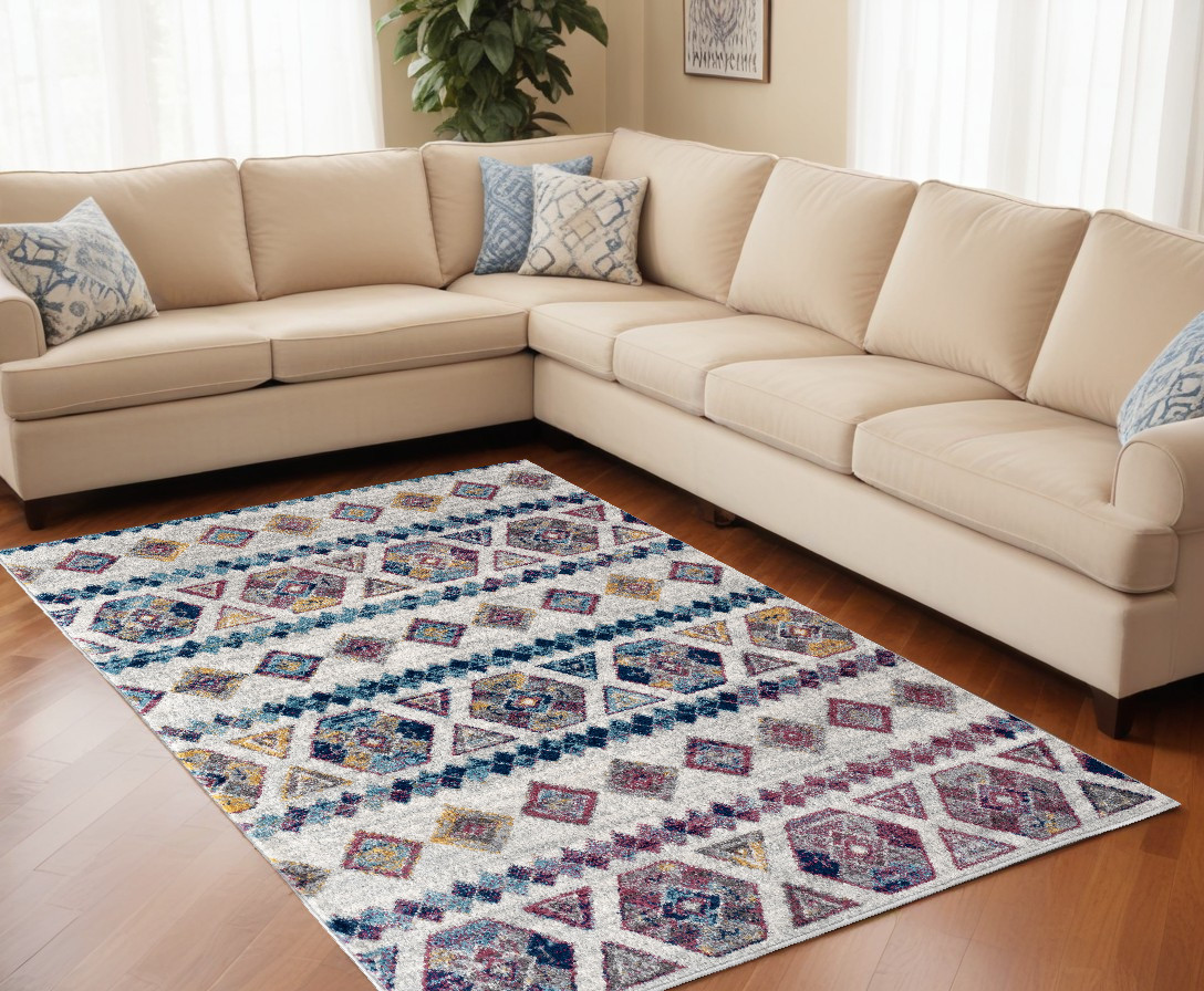 9" X 12" Ivory Blue and Orange Geometric Power Loom Area Rug