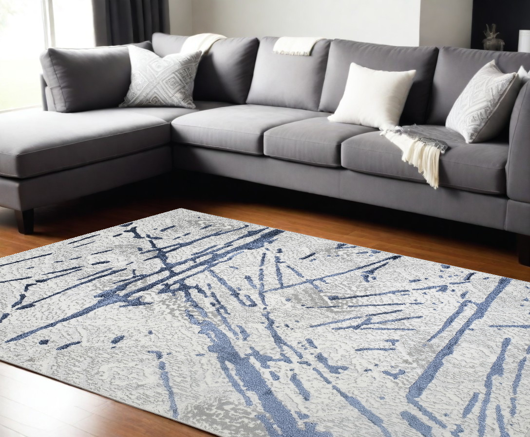 9" X 12" Ivory and Blue Abstract Area Rug