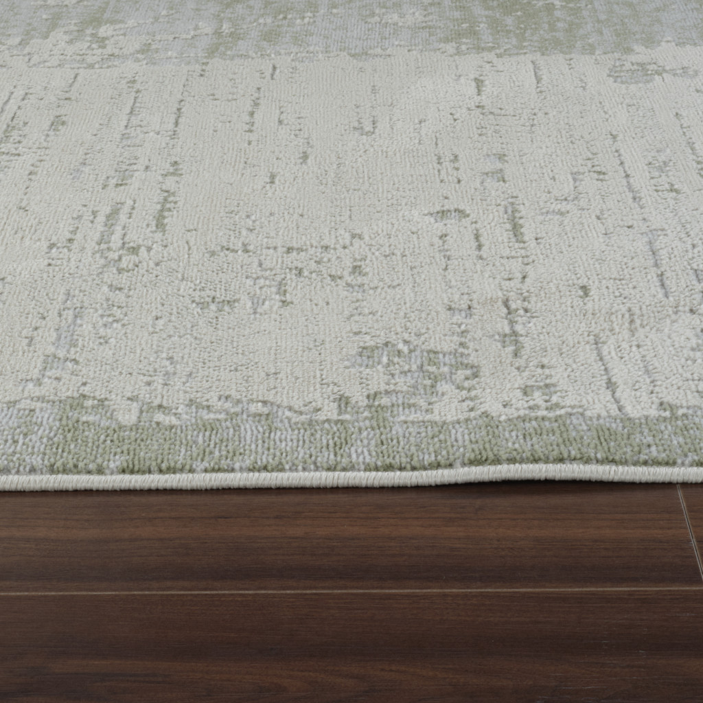 5" X 8" Beige and Green Abstract Distressed Area Rug