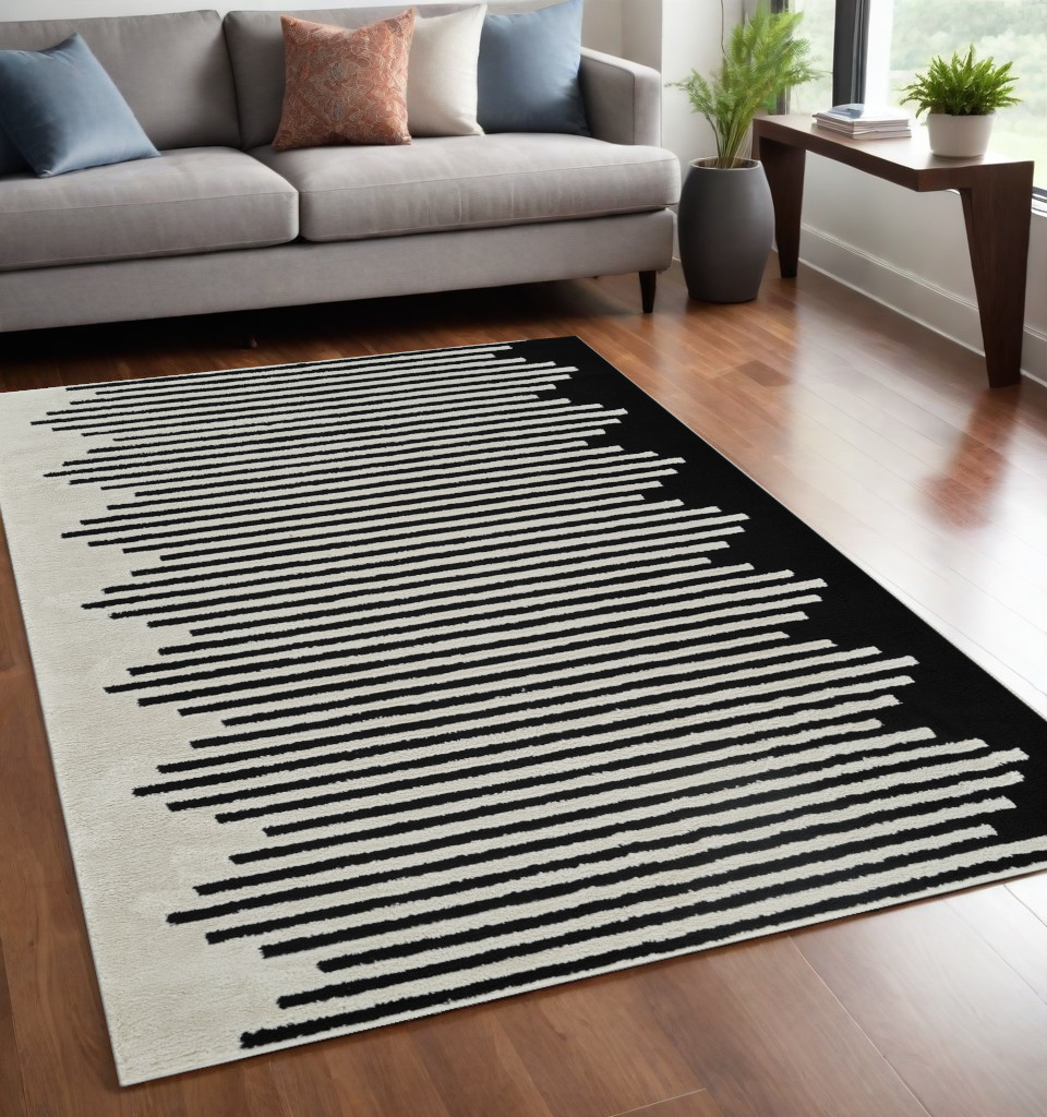 5" X 8" Cream and Black Abstract Worn Faded Area Rug