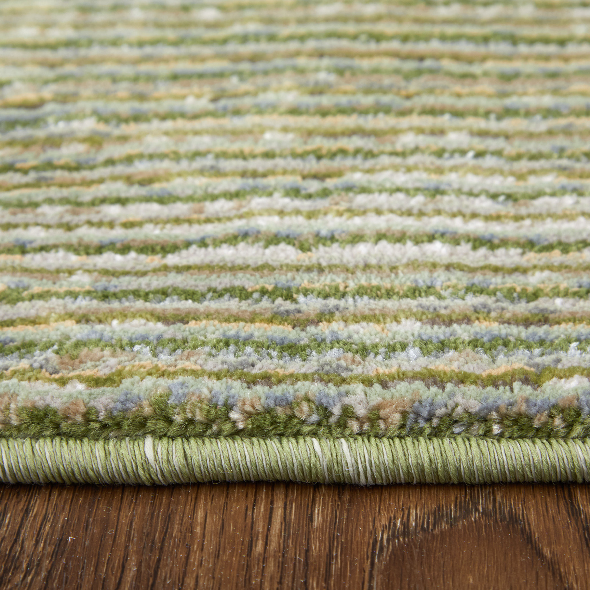 2" X 3" Tan and Green Power Loom Area Rug