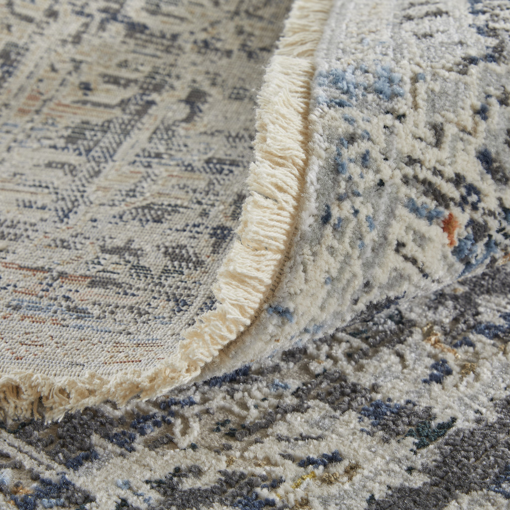 3" X 5" Ivory and Gray Abstract Power Loom Worn Faded Area Rug With Fringe