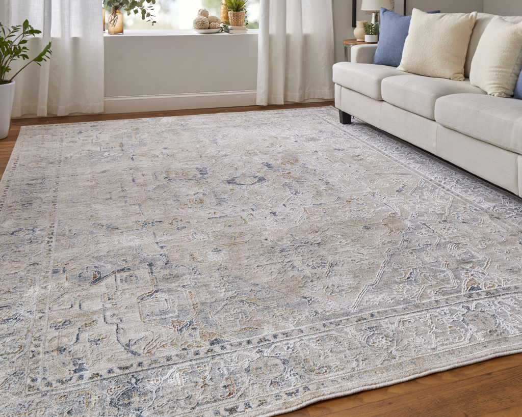 9" X 13" Ivory Taupe and Blue Oriental Power Loom Worn Faded Area Rug With Fringe