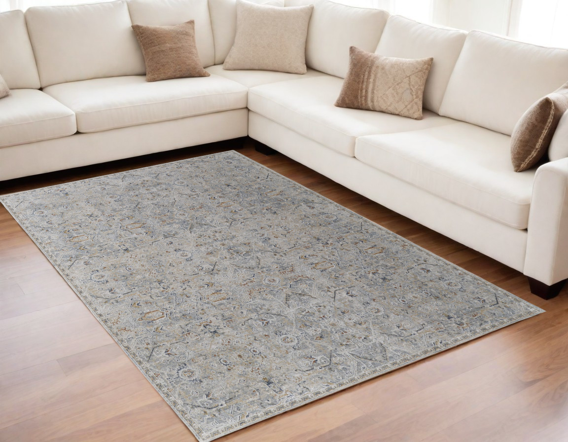 5" X 8" Ivory Tan and Blue Abstract Power Loom Worn Faded Area Rug With Fringe