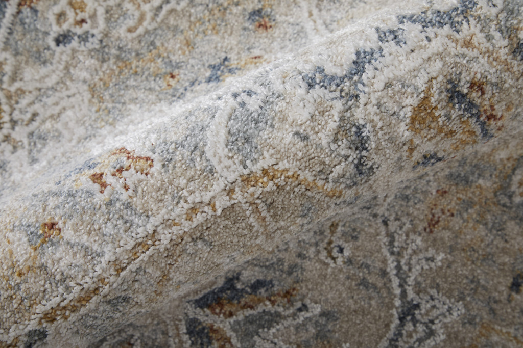 9" X 13" Ivory Tan and Blue Abstract Power Loom Worn Faded Area Rug With Fringe